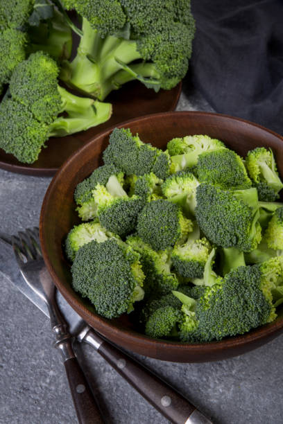 istock Fresh broccoli whole and sliced in a wooden bowl. 1062220100