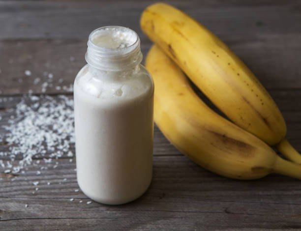 istock banana smoothie on wood background 1062222260