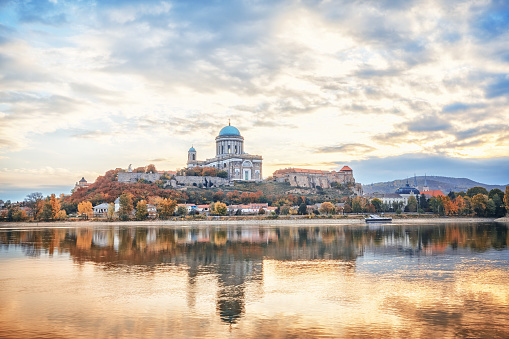 Esztergom, Hungary, Europe. Basilica of the Blessed Virgin Mary. Amazing morning view over Danube river, beautiful reflections mirrored in water. Long exposure landscape.