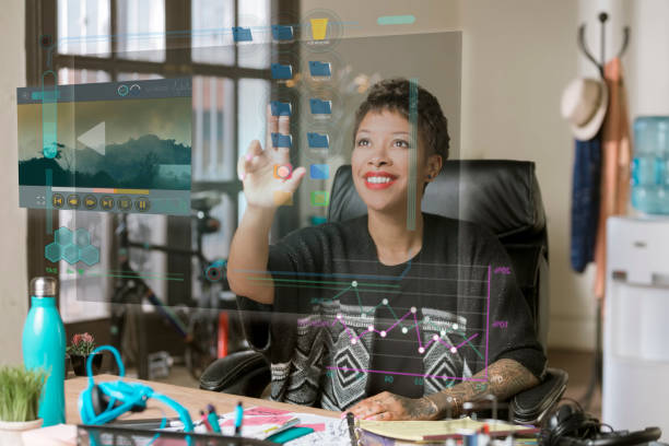 Smiling Professional Woman Operating a Futuristic Desktop Computer Screen