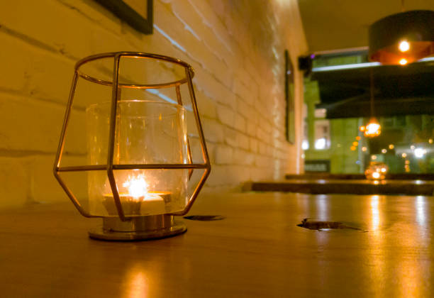 istock Candle on a wooden table top in a trendy bar 1062228480