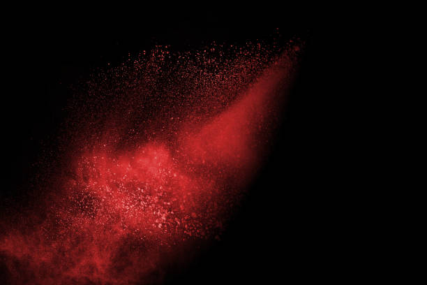 istock abstract red powder explosion on black background.abstract red powder splatted on black background. Freeze motion of red powder exploding. 1062230346