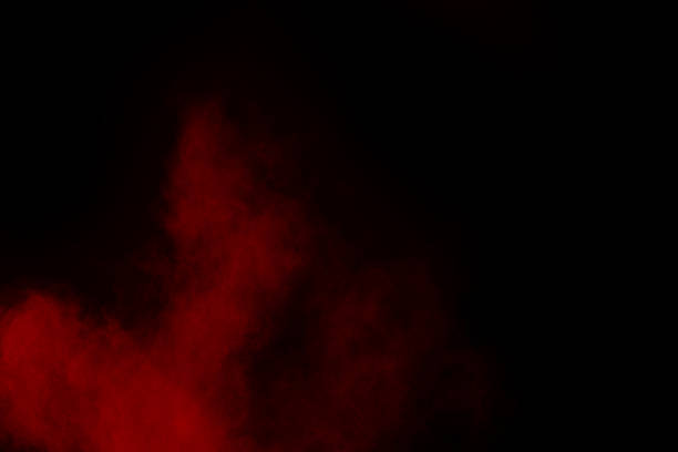istock abstract red powder explosion on black background.abstract red powder splatted on black background. Freeze motion of red powder exploding. 1062230524