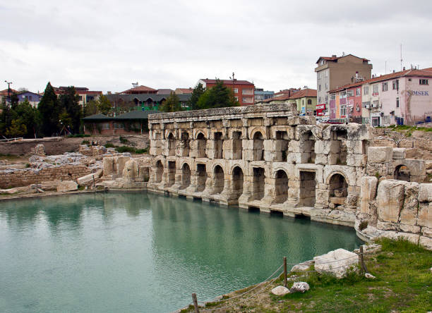 Yozgat, Turkey - April 21, 2018: People on the street with roman bath view in sarıkaya Yozgat. It was built by romans at 2nd century.