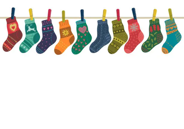 Vector illustration of Warm socks set hang on the rope