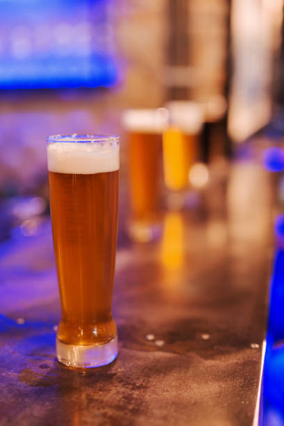 istock Glass of fresh beer on table. 1062239104