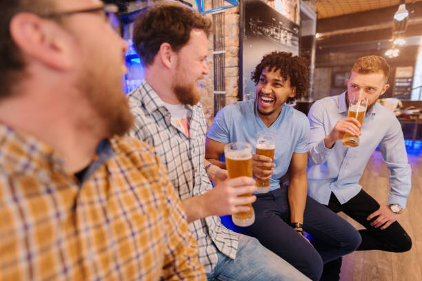 istock Friends sitting at bar and drinking beer. 1062241094