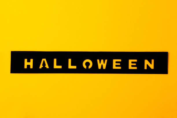 istock Hand made scrabbooking inscription HALLOWEEN layout on a yellow-orange background. 1062242998