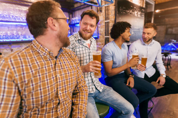 istock Friends sitting at bar and drinking beer. 1062243378