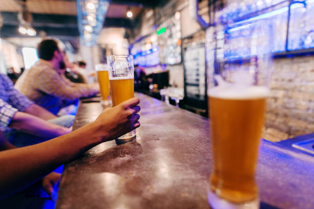 istock Hand holding glass of beer. 1062246556