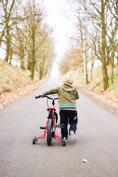istock Little child boy on bicycle in park outdoor 1062249708