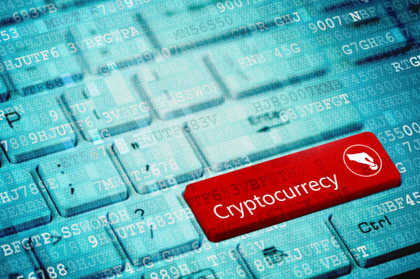 Cryptocurrency concept: blue digital laptop keyboard with word Cryptocurrency and hand and coin icon stock photo