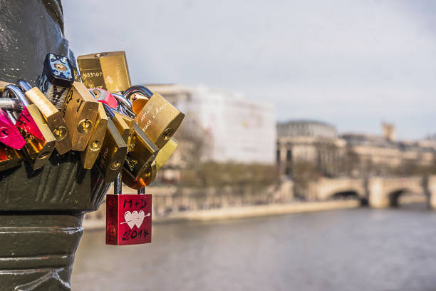 Colorful love locks in Paris on the Arts Bridge with a soft and clear background.