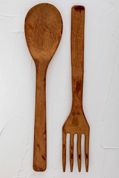 istock Wooden spoon and fork on white background with texture. Space to insert your text here. Letter for restaurants. (Food concept of spoon, pot). 1062259498