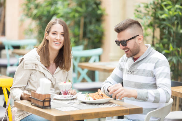 istock Young couple having a breakfast  in cafe outdoors 1062260066