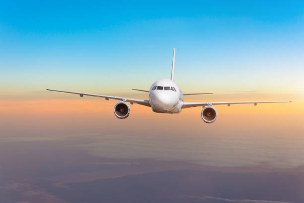 istock Airplane plane in the sky at sunset sky. 1062269636
