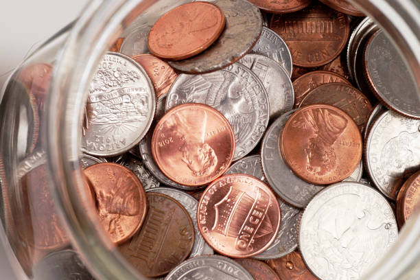 istock Glass Jar of Coins Isolated on White 1062272068