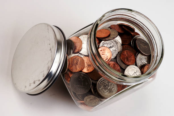 istock Glass Jar of Coins Isolated on White 1062272080