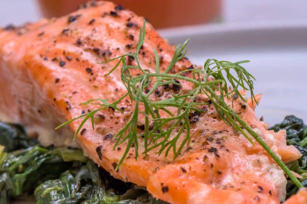 istock Grilled salmo trutta on spinach - healthy food 1062272636