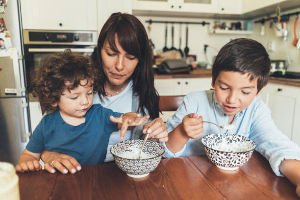 istock Woman and two kids eating breakfast 1062274306