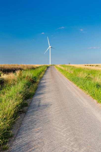 istock Road Leading To Wind Turbine 1062274486