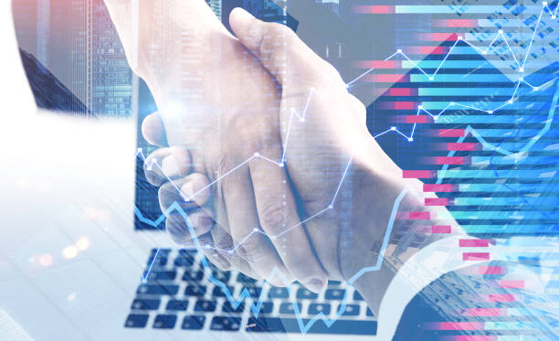 istock Handshake in company office, forex diagrams 1062280660