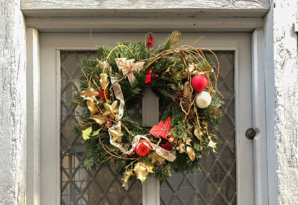istock Gold christmas wreath on a white door 1062289192