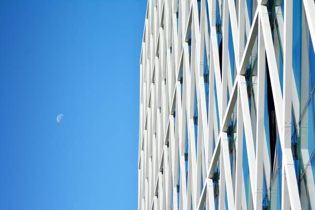 istock Modern office building facade abstract fragment, shiny windows in steel structure. 1062295546