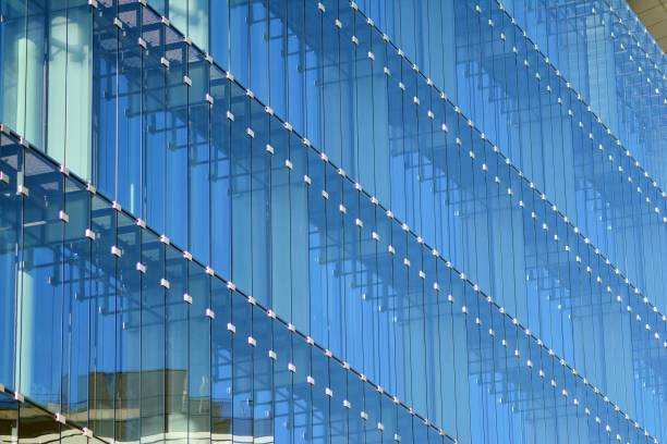 istock Modern office building facade abstract fragment, shiny windows in steel structure. 1062297174