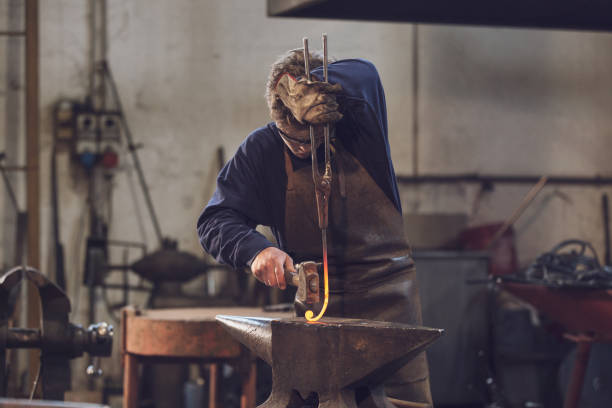 istock Young blacksmith working with red hot metal 1062314206