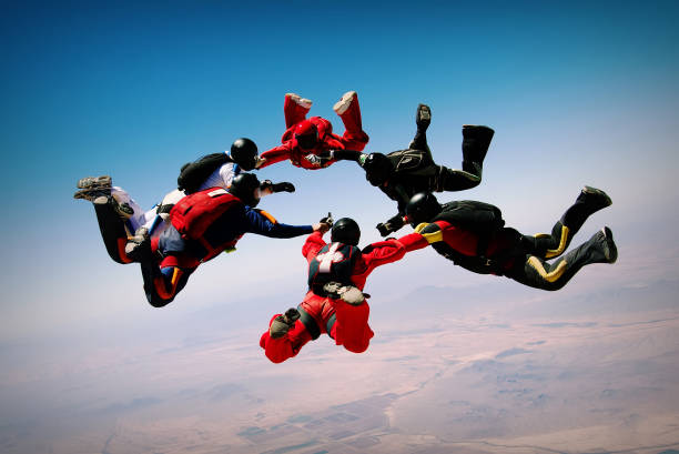 Skydiving teamwork formation Group of skydivers making a circle skydiving stock pictures, royalty-free photos & images