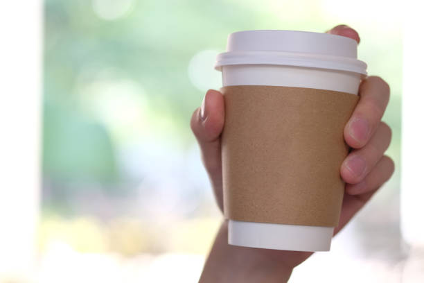 istock Hand holding brown paper cup. 1062326382