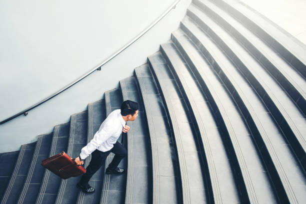 istock Successful businessman running fast upstairs Success concept 1062330914