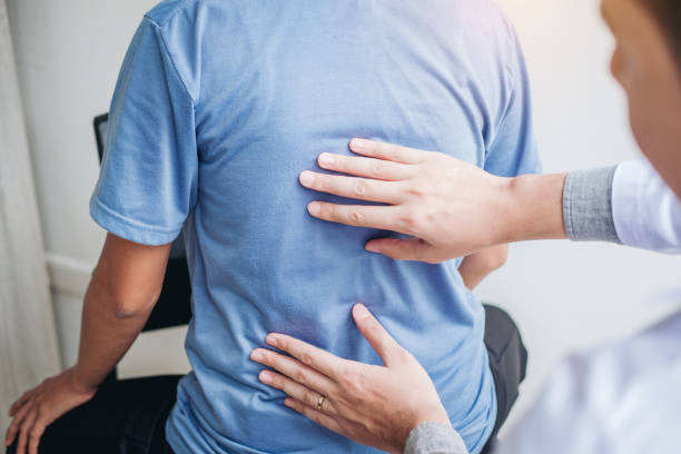 istock Doctor consulting with patient Back problems Physical therapy concept 1062332218