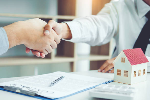 istock Business people negotiating a contract handshake between two colleagues 1062332318