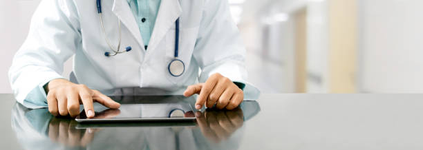 istock Doctor with tablet computer at hospital office. 1062332468