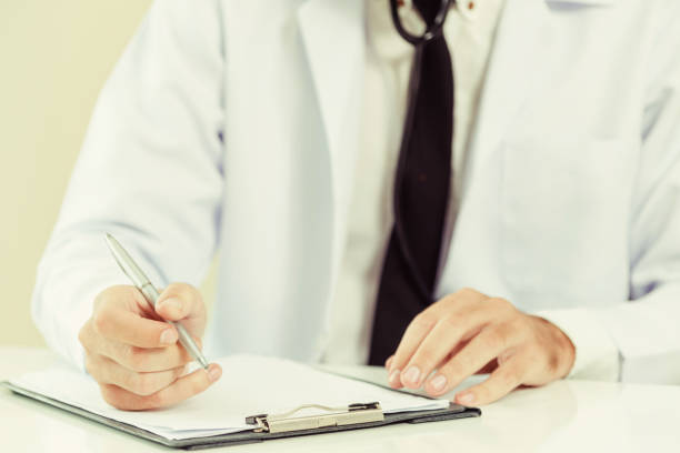 istock Doctor in hospital writing on a paper document. 1062337238
