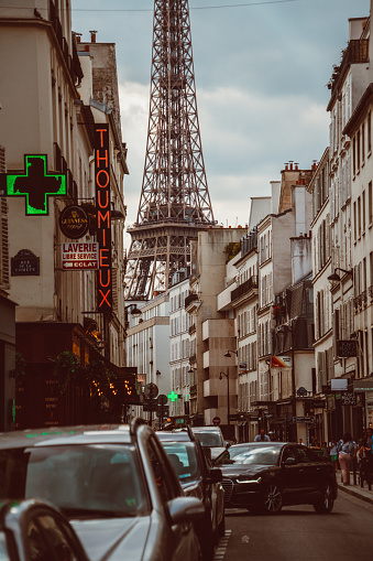 Interesting angle of Eiffel Tower in the end of a street in Paris