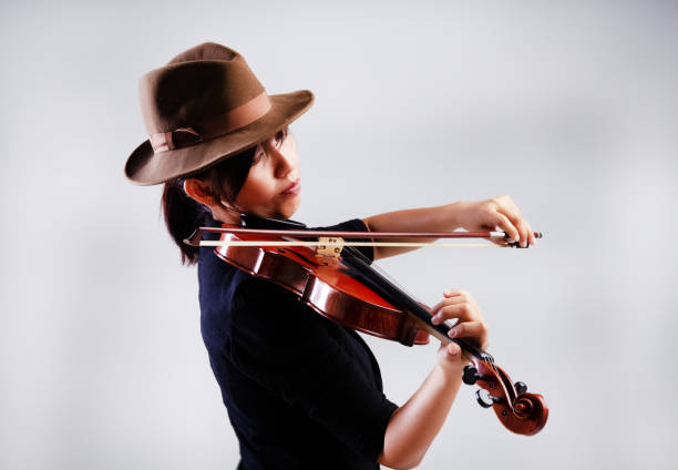 istock The lady is wearing black suit,playing violin 1062348466