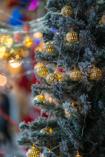 istock Decorated and illuminated christmas tree with warm toned ball and cold toned pine branches 1062357238