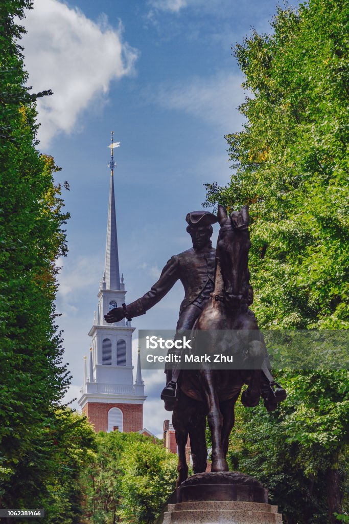 Statue of Paul Revere and spire of Old North Church between trees, in North End, Boston, USA Statue of Paul Revere and spire of historical Old North Church between trees, in North End, Boston, USA Boston - Massachusetts Stock Photo