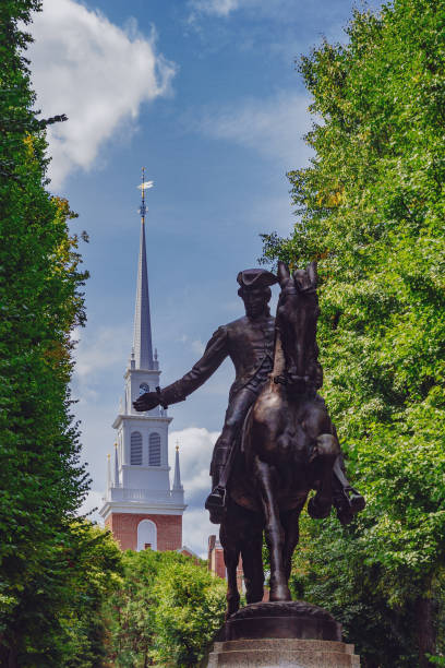 Statue of Paul Revere and spire of Old North Church between trees, in North End, Boston, USA Statue of Paul Revere and spire of historical Old North Church between trees, in North End, Boston, USA north end boston photos stock pictures, royalty-free photos & images