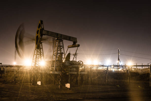 istock Working oil pump jack at night time. 1062385942