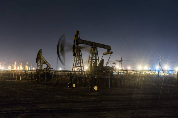 istock Working oil pump jack at night time. 1062385956