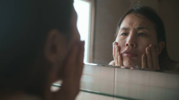 istock Frustrated sad upset beautiful woman is squeezing out pimples 1062387710