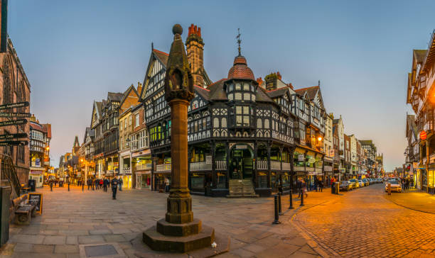 Sunset view of traditional tudor houses alongside the Bridge street in the central Chester, England Chester, UK, April 7, 2017: Sunset view of traditional tudor houses alongside the Bridge street in the central Chester, England chester england stock pictures, royalty-free photos & images
