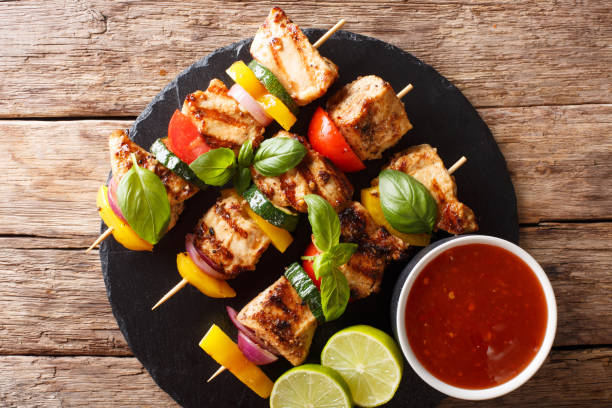 istock spicy grilled chicken kebabs with vegetables served with ketchup close-up. horizontal top view 1062402144
