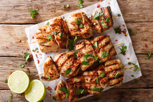 istock Afghanistan's barbecue: grilled chicken skewers Kebab e Murgh close-up on a table. Horizontal top view from above 1062402814