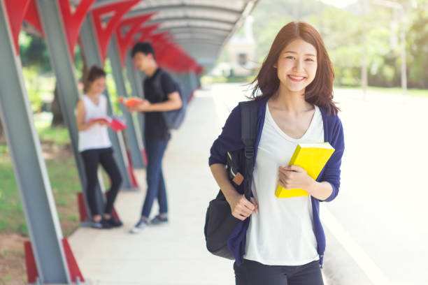 istock Young student walking in school with happy smiling with blurred another