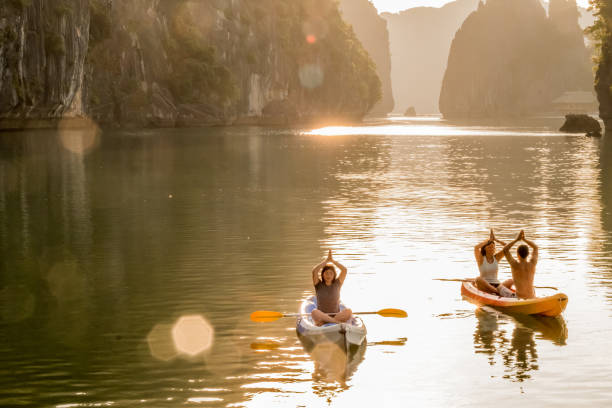 sunrise yoga and meditation in kayaks, lan ha bay, vietnam - sea zen like landscape water imagens e fotografias de stock